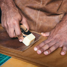 close up image of Otter Wax being applied by hand