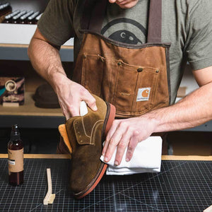 Otter Wax suede cleaner being wiped off shoe